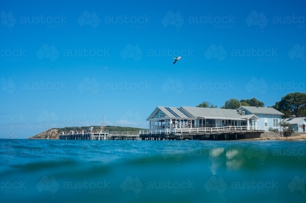 Looking across water at wharf restaurant - Australian Stock Image