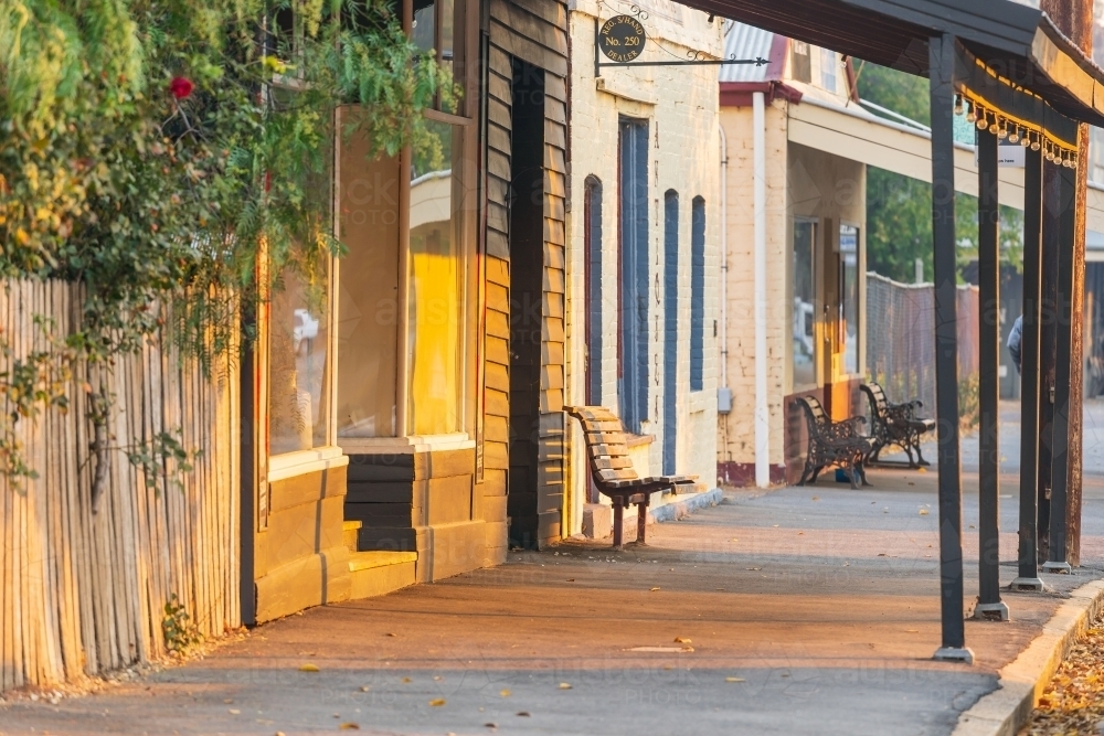 Looking along a footpath of old shop fronts and verandas - Australian Stock Image