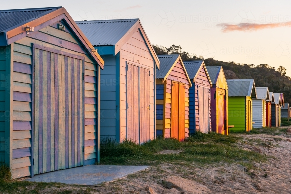 Looking along a row of colorful timber bathing boxes - Australian Stock Image