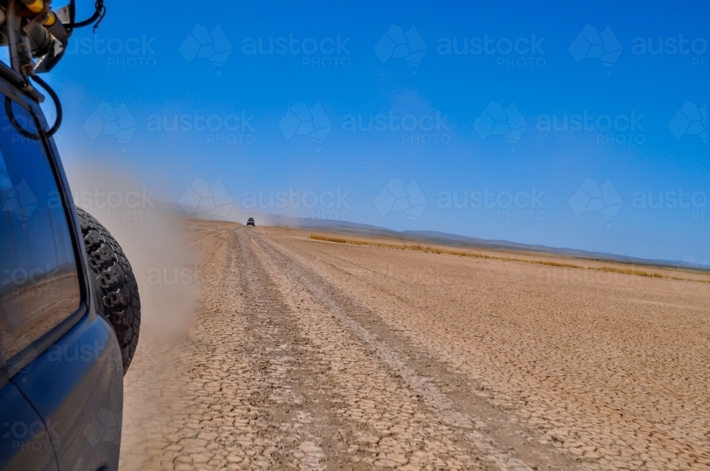 looking back traveling on a dirt road - Australian Stock Image