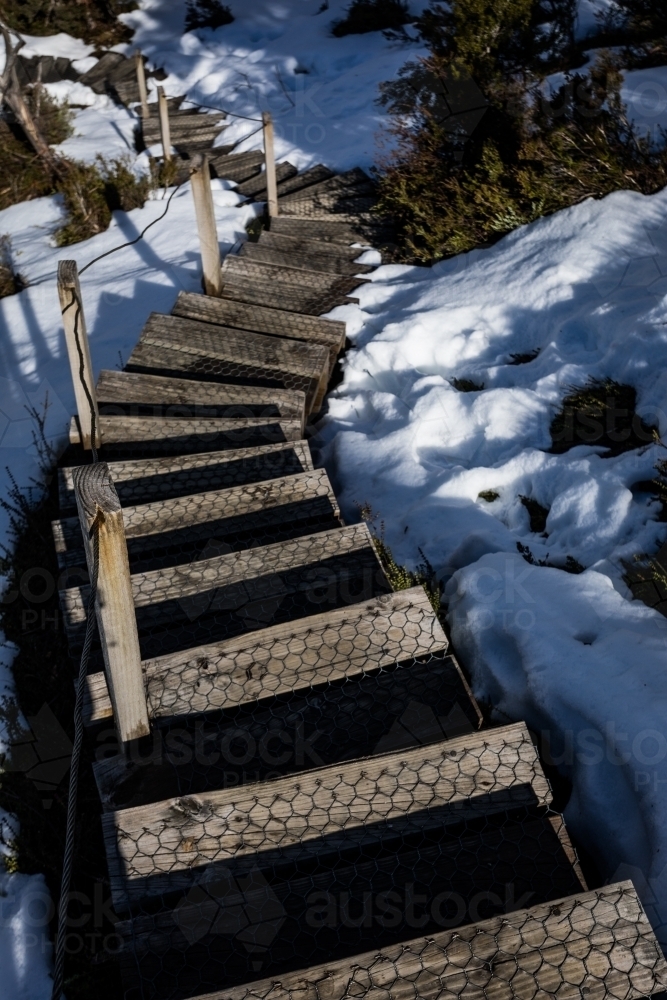 Looking down a flight of steps in the snow - Australian Stock Image