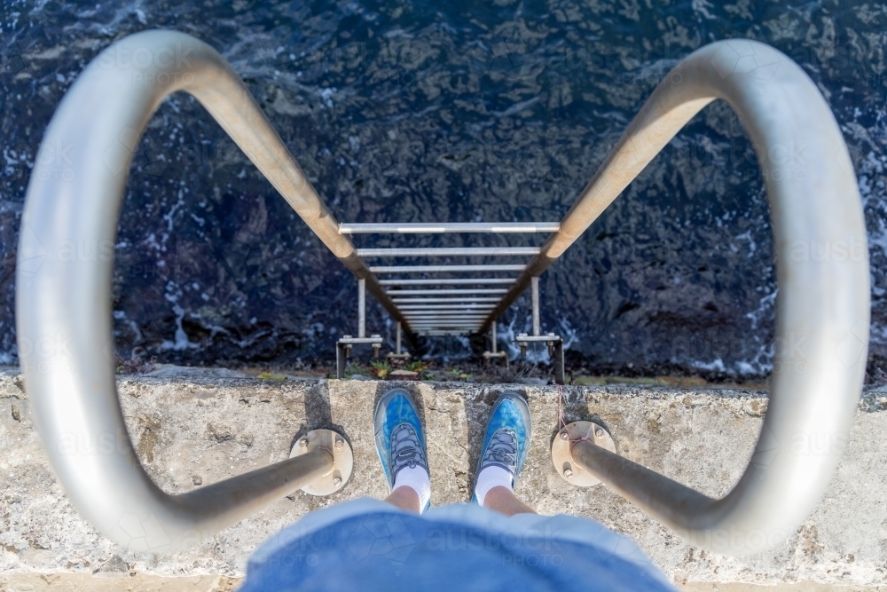 Looking down a ladder into the sea - Australian Stock Image