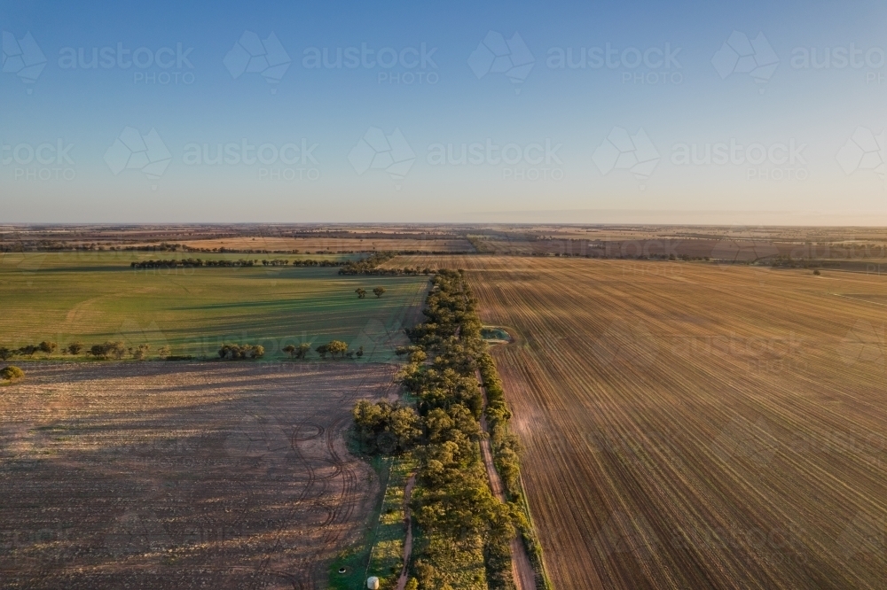 Looking down along a country road at sunrise - Australian Stock Image