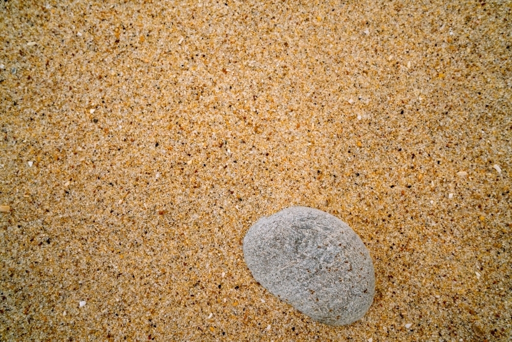 Looking Down at a Stone on the Sand - Australian Stock Image