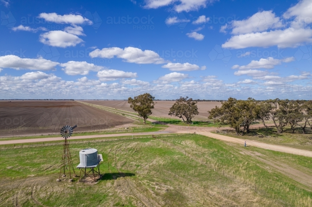 Looking down at a windmill and water tank in a rural setting - Australian Stock Image