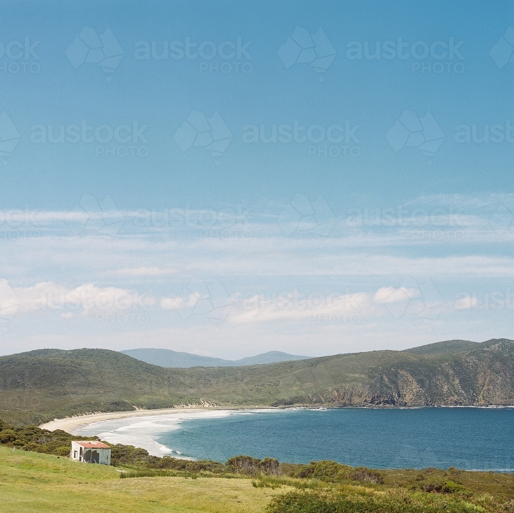 Looking down at dramatic landscape of coastal cove - Australian Stock Image