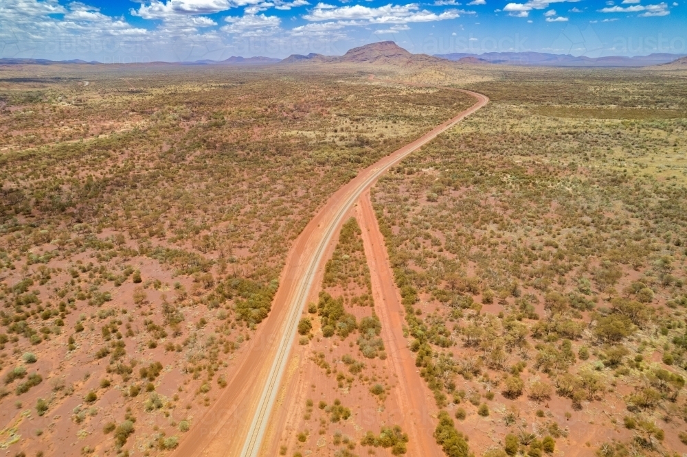 Looking down at intersecting dirt tracks at the red terrain earth - Australian Stock Image