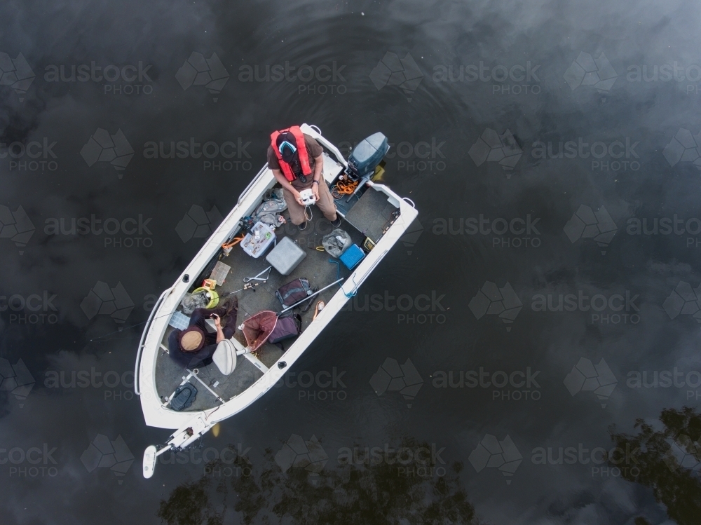 Looking down at Two Fishermen in a Messy Boat - Australian Stock Image