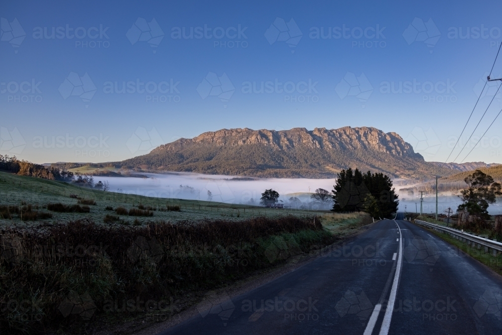 Looking down Claude Road to a foggy valley and Mt Roland - Australian Stock Image
