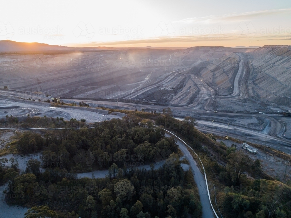 looking down into an open cut coal mine in Bulga area of the Hunter Valley at dusk - Australian Stock Image