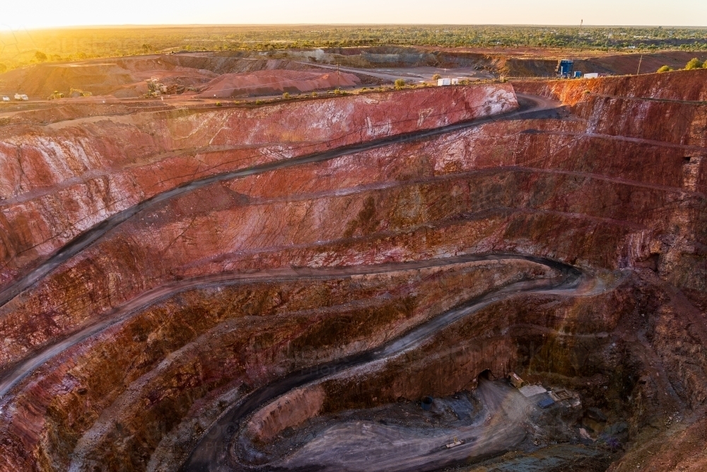 Looking down into an open cut mine with roads winding down to the a bottom of the pit - Australian Stock Image