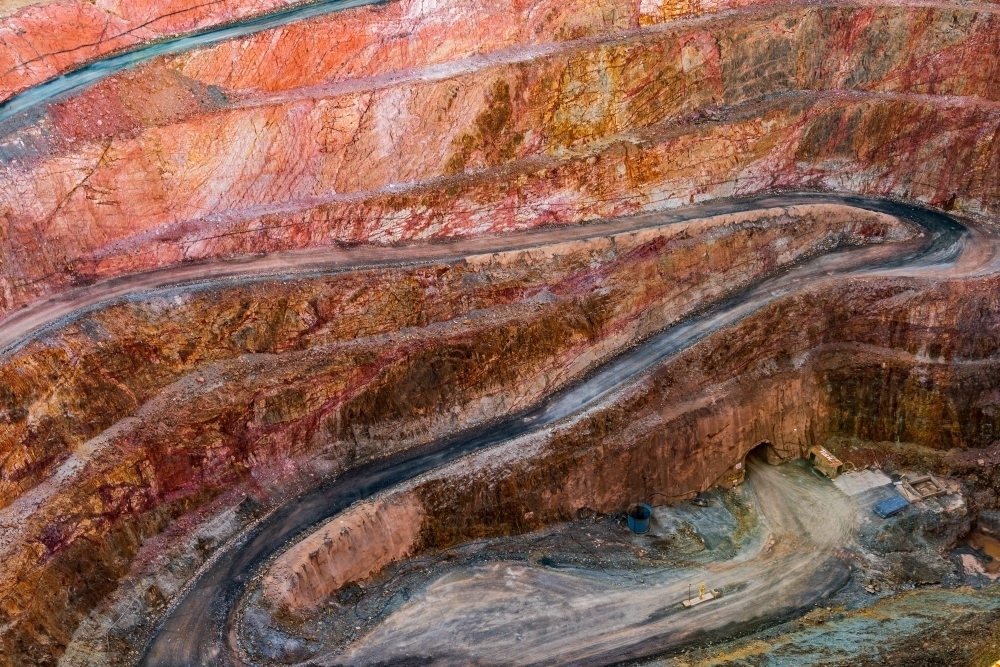 Looking down into an open cut mine with roads winding down to the a bottom of the pit - Australian Stock Image