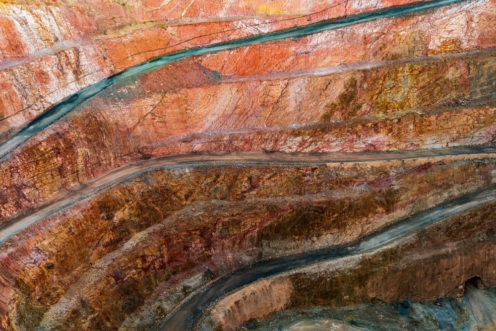 Looking down into an open cut mine with roads winding down to the a bottom of the pit - Australian Stock Image