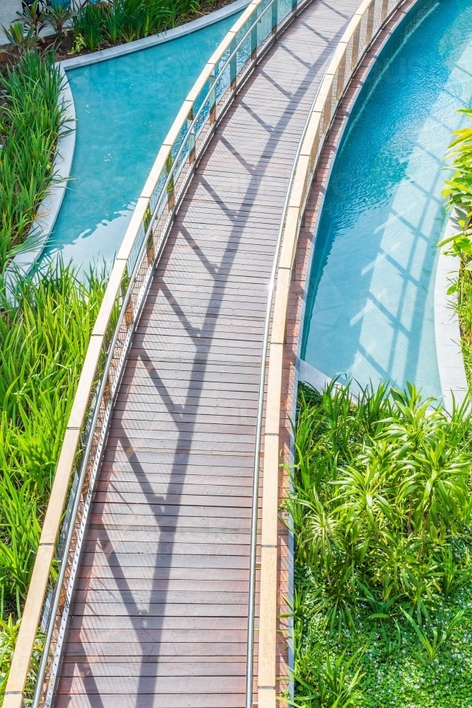 Looking down on a curved boardwalk over pool - Australian Stock Image