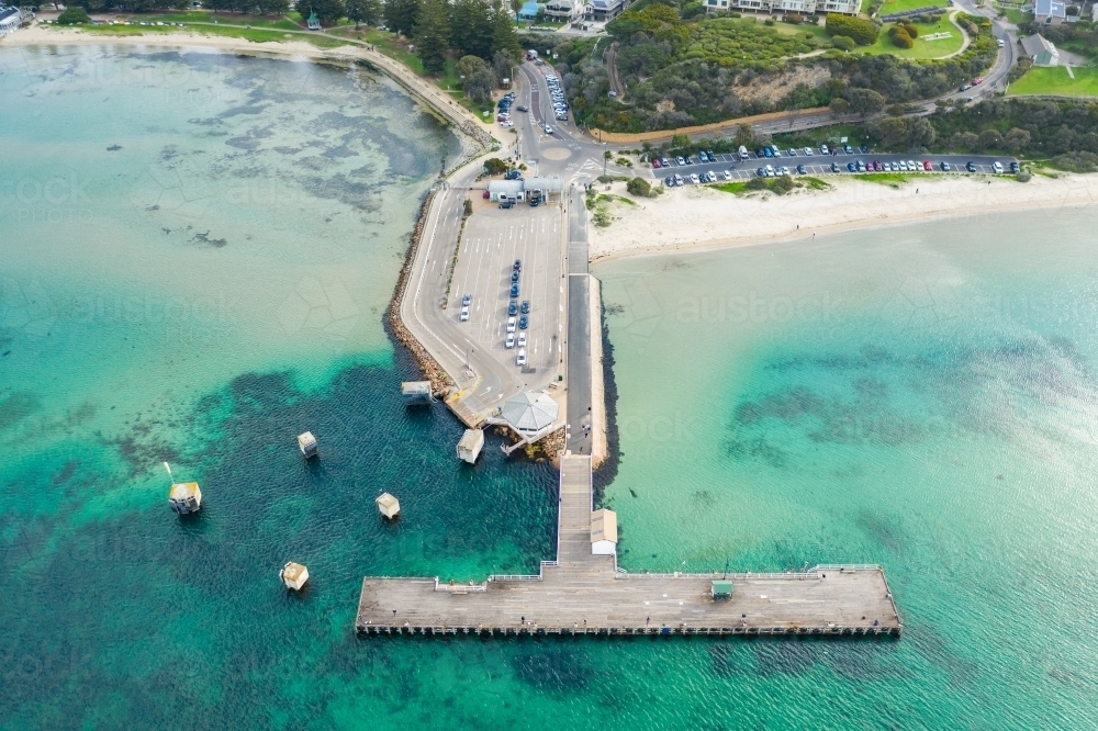Looking down on a ferry terminal and jetty off a coastal town - Australian Stock Image
