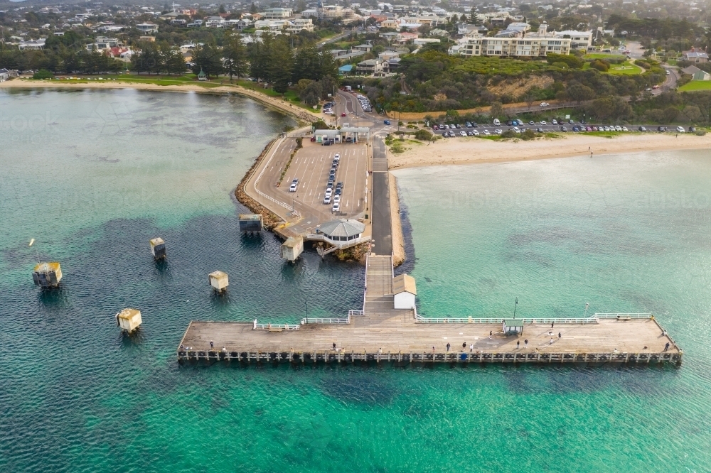 Looking down on a ferry terminal and jetty off a coastal town - Australian Stock Image