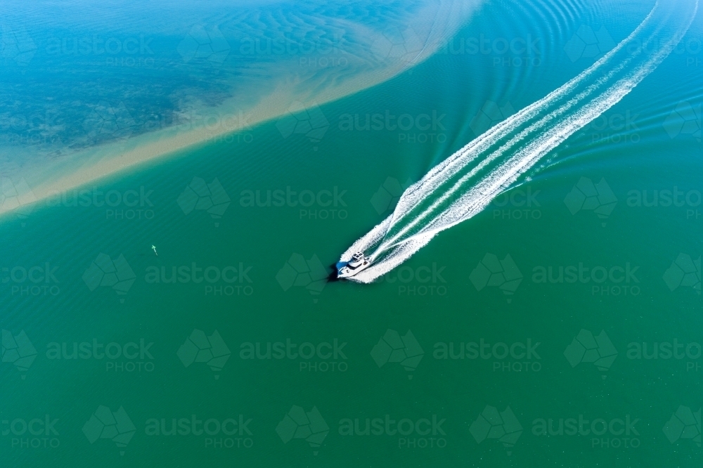 Looking down on a powerboat in estuary. - Australian Stock Image