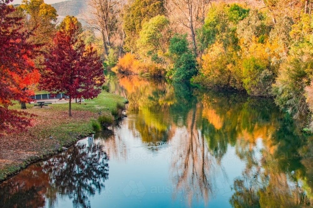 Looking down on a river surrounded by the colours of autumn - Australian Stock Image