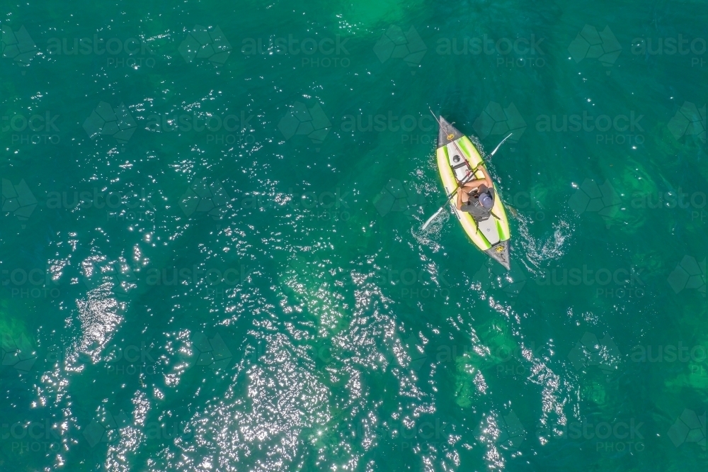Looking down on a solitary kayaker on the sea - Australian Stock Image