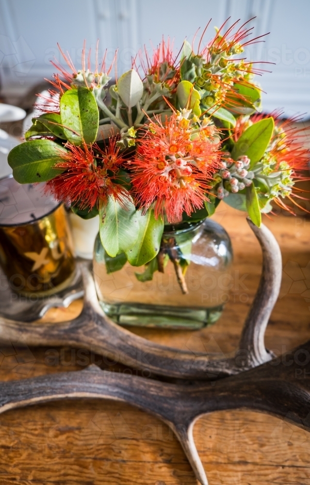 Looking down on a vase of New Zealand Christmas Bush flowers styled on a coffee table - Australian Stock Image