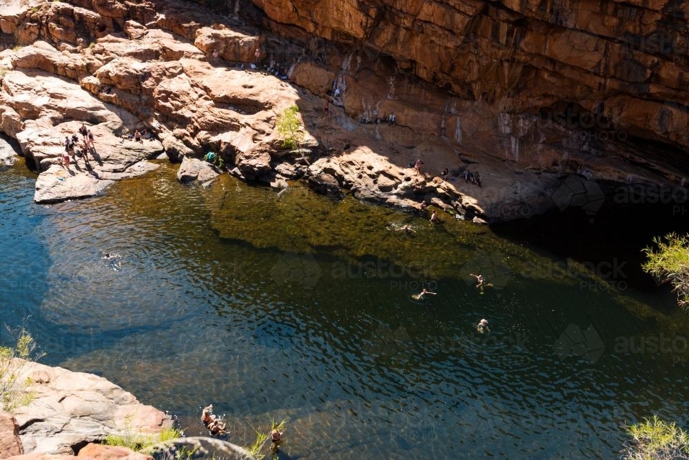 Looking down on people swimming in rock pool - Australian Stock Image