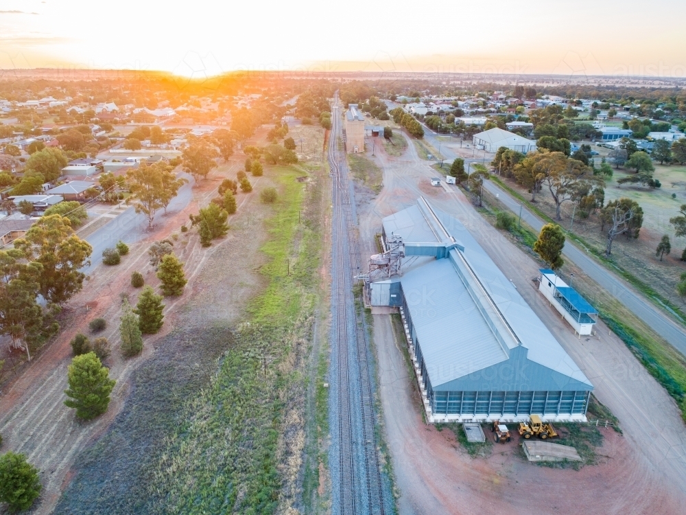 Looking down on storage sheds and railways lines running to a collection of grain silos - Australian Stock Image