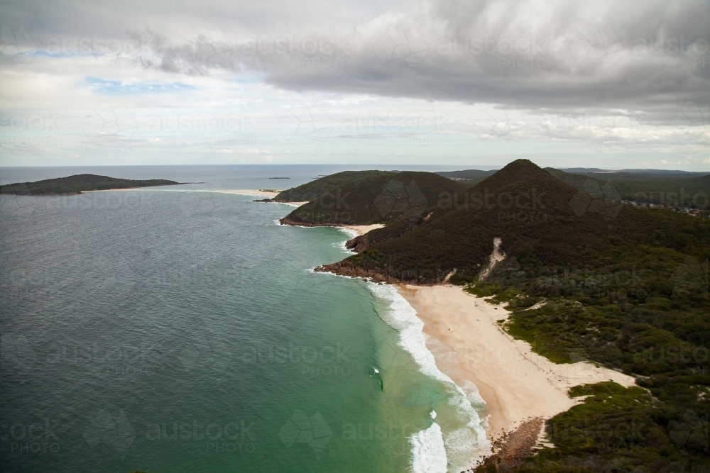 Looking down on waves washing up on seaside beach - Australian Stock Image