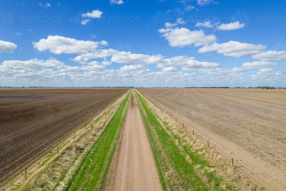 Looking down over a dirt road leading into the distance - Australian Stock Image