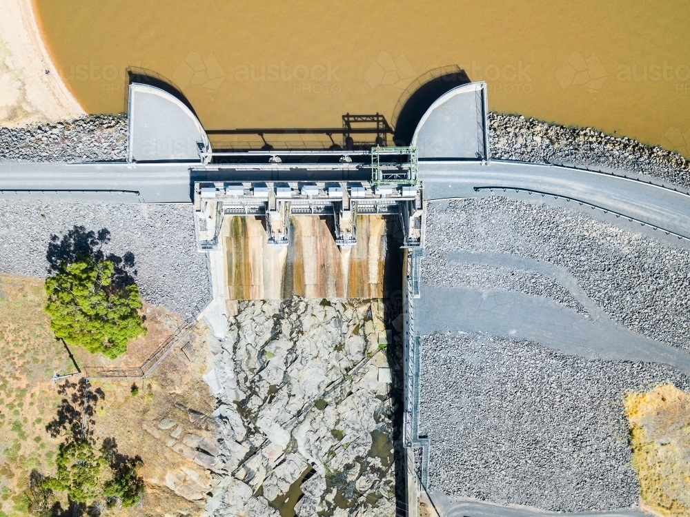 Looking down over the gates and dam wall of a water reservoir - Australian Stock Image