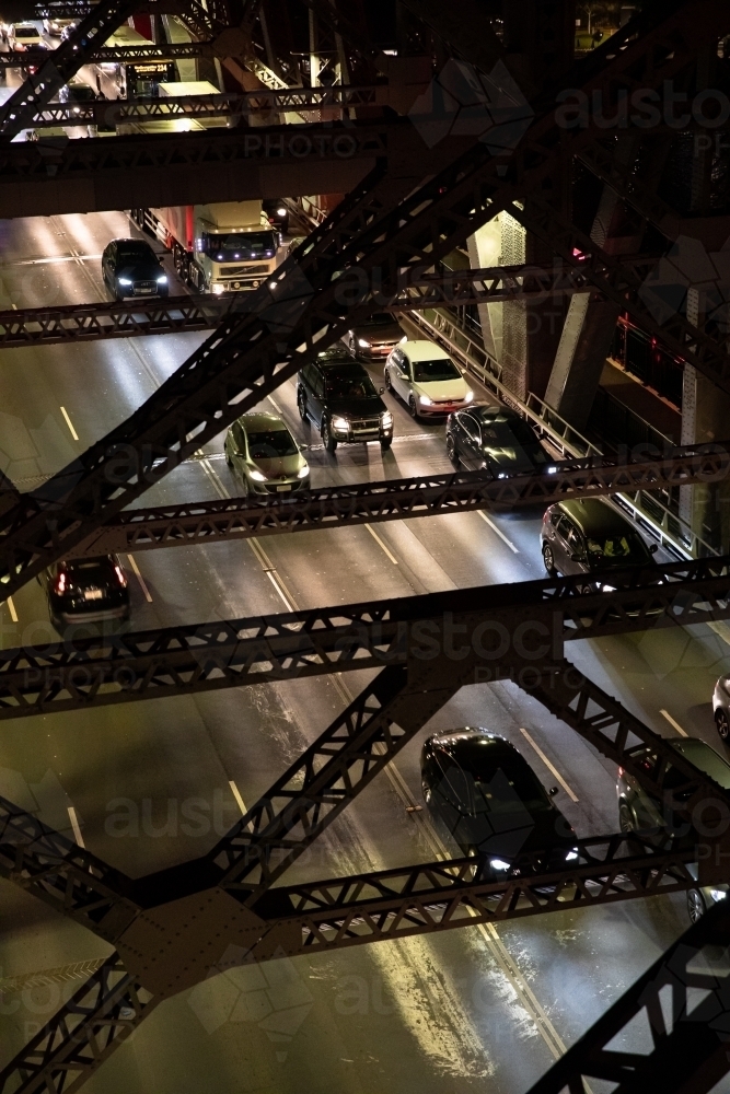 Looking down through the structure of the Story Bridge at traffic during the night. - Australian Stock Image