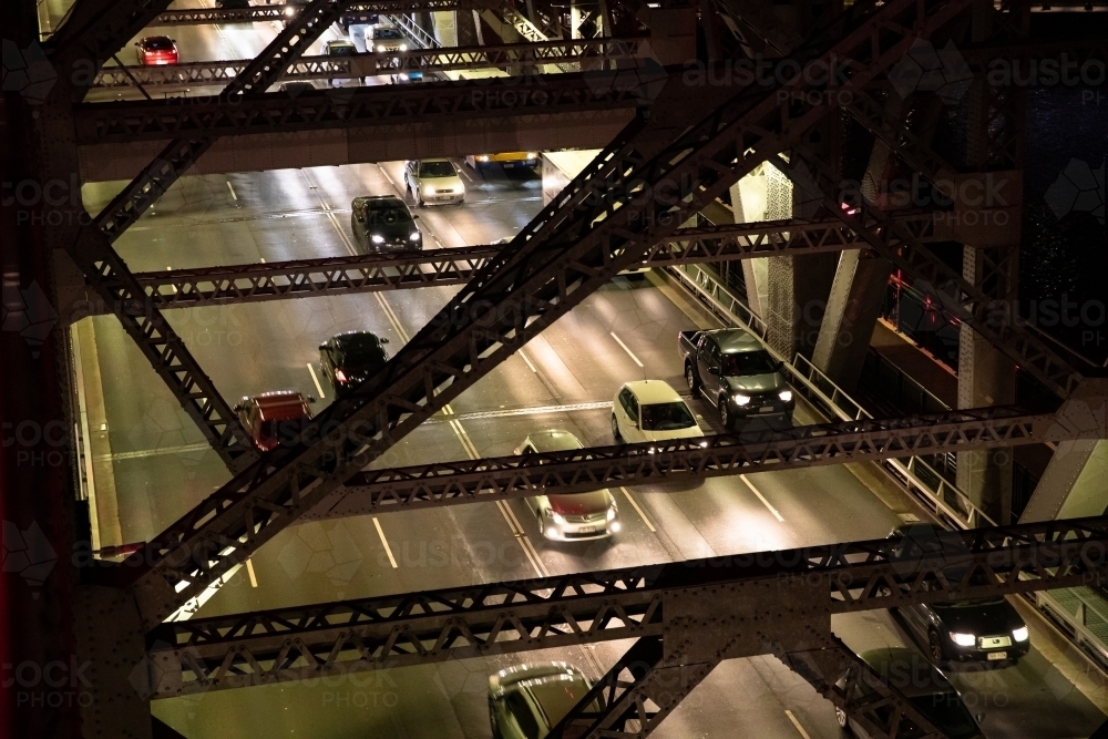 Looking down through the structure of the Story Bridge at traffic during the night. - Australian Stock Image