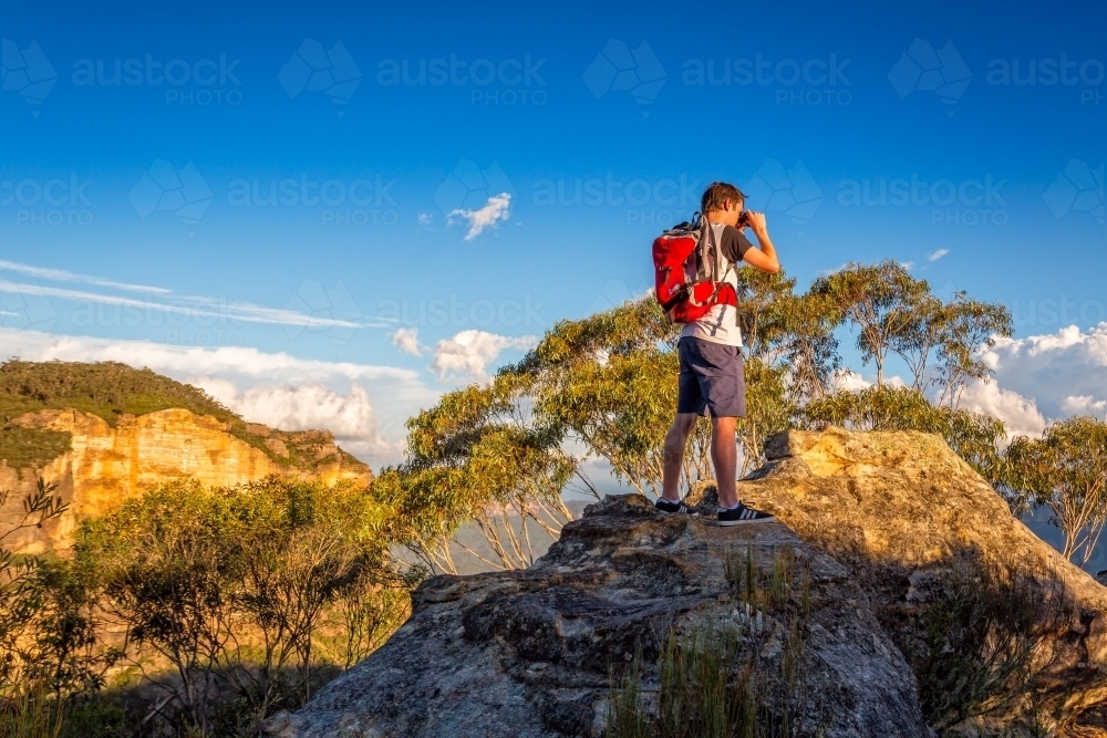 Looking out across the mountains and escarpment from a rocky cliff that juts out from main escarpmen - Australian Stock Image