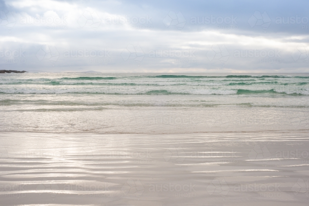 Looking out at calm ocean under afternoon clouds - Australian Stock Image