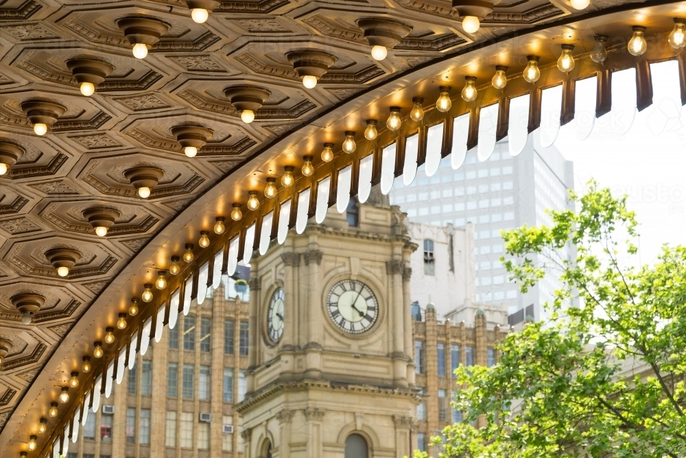 Looking out from under a theatre verandah at historic clock tower - Australian Stock Image