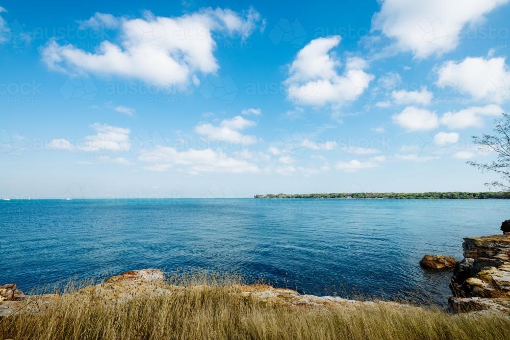 Looking out over clear blue waters of Darwin harbour on a sunny day - Australian Stock Image