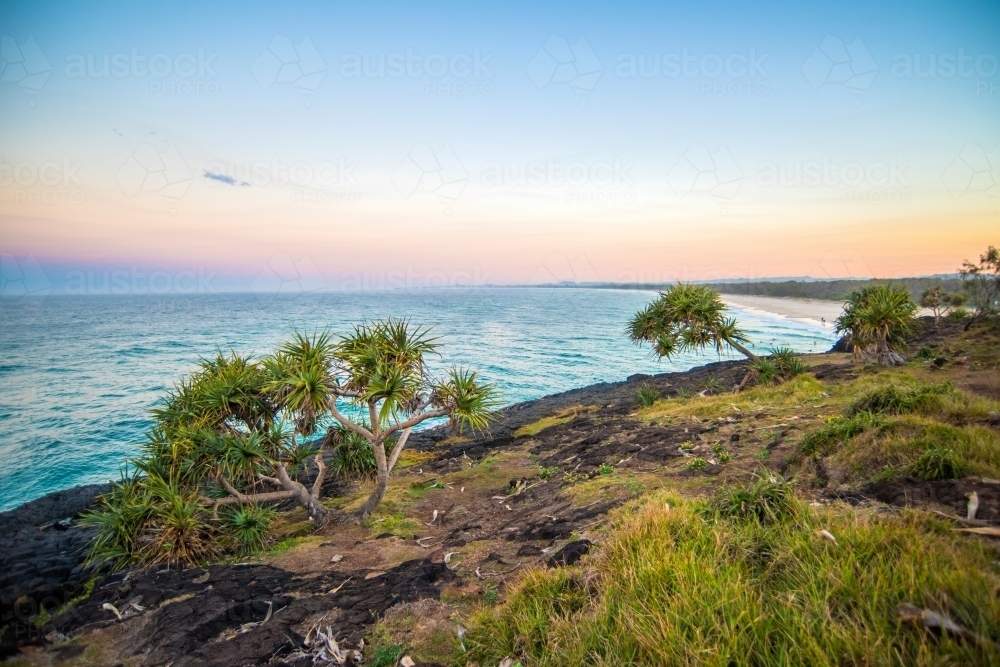 Looking out to the coloured sky to the ocean at Fingal Beach - Australian Stock Image