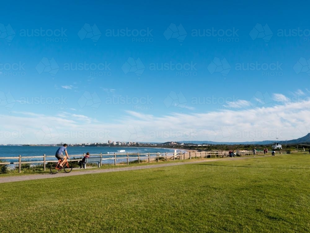 Looking south to Wollongong with cyclist on the cycle path - Australian Stock Image