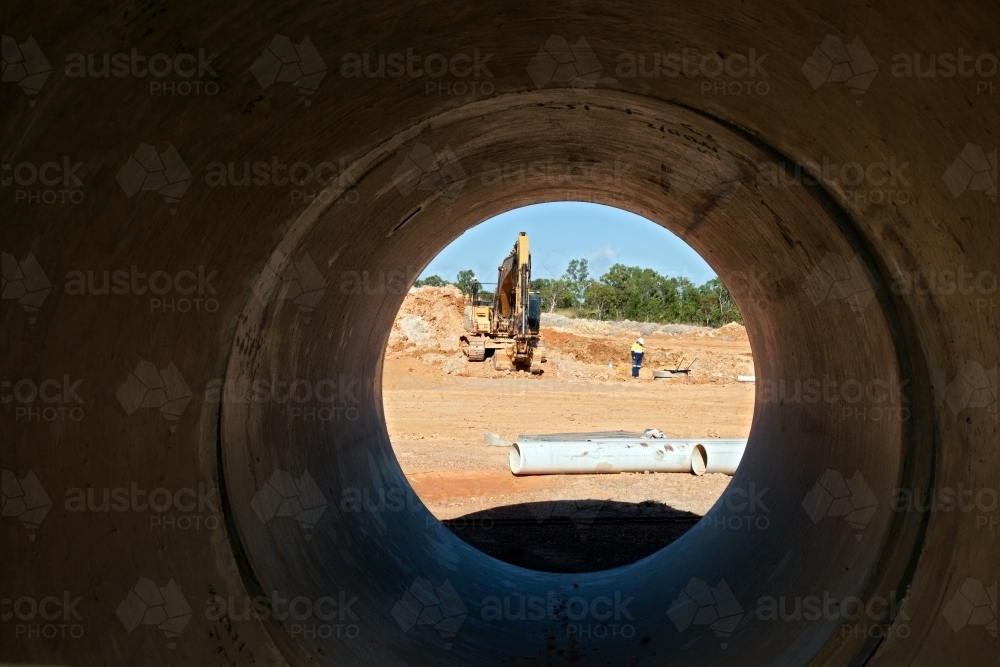 Looking through a drain pipe at an industrial building site - Australian Stock Image