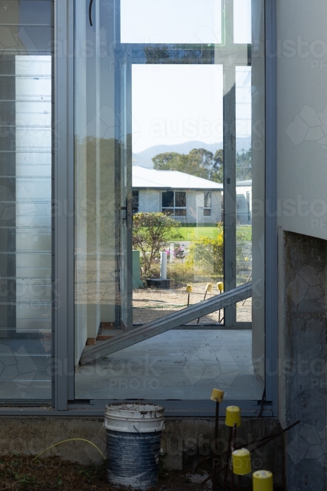 Looking through glass panels on new home under construction - Australian Stock Image