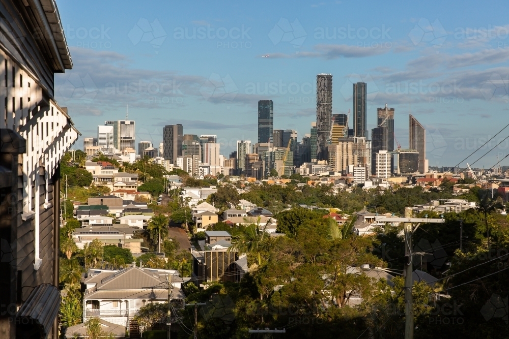 looking towards Brisbane City from Paddington with an old timber house in frame - Australian Stock Image