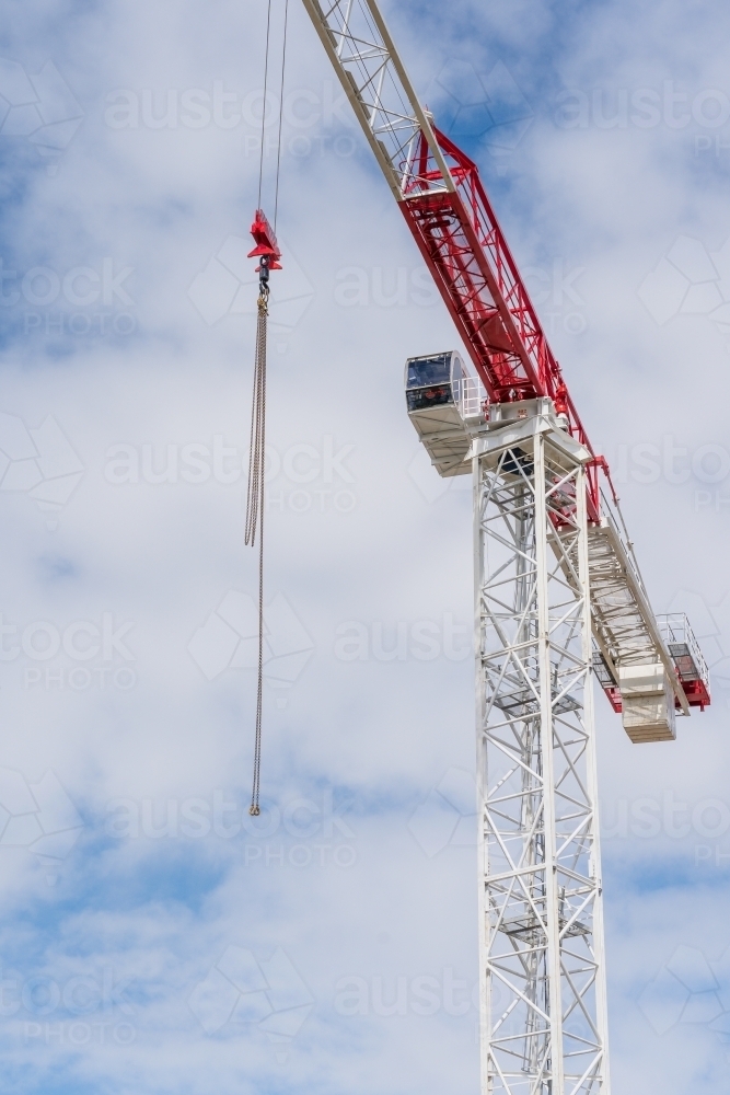 Looking up at a large construction crane dangling a chain - Australian Stock Image