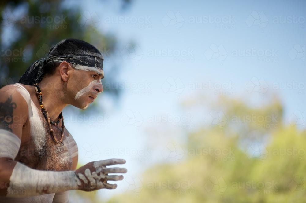 Looking up at Aboriginal Dancer Performing Outdoors - Australian Stock Image