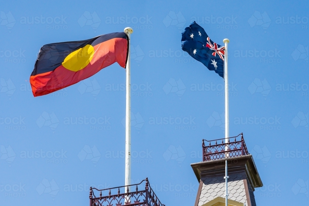 Looking up at an Australian and Aboriginal flag flying next to one another - Australian Stock Image