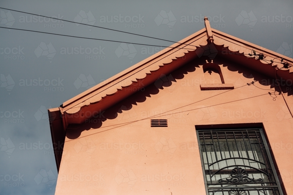 Looking up at roof of orange home against grey sky - Australian Stock Image