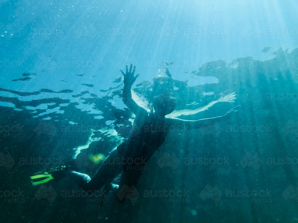 Looking up at Snorkeller floating on surface - Australian Stock Image