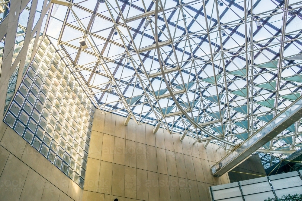 Looking up at the ceiling of a large steel and glass atrium - Australian Stock Image