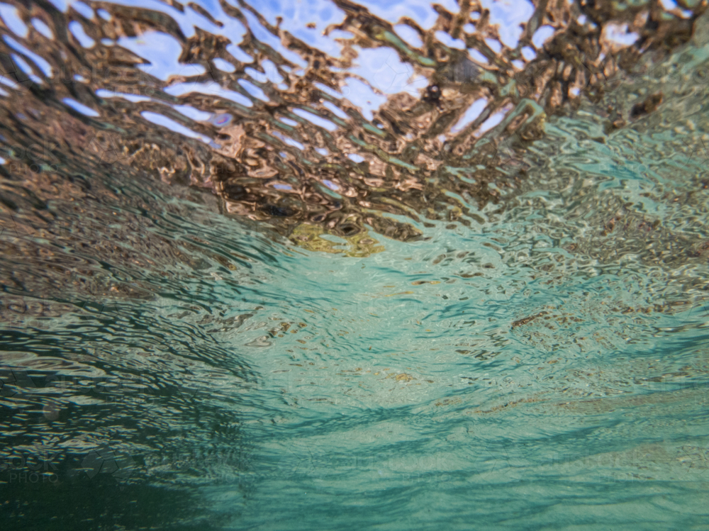 Looking up at the surface of the ocean from underwater - Australian Stock Image