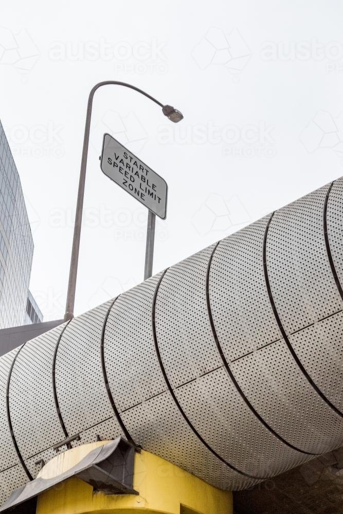 looking up at variable speed limit zone sign on overhead freeway - Australian Stock Image