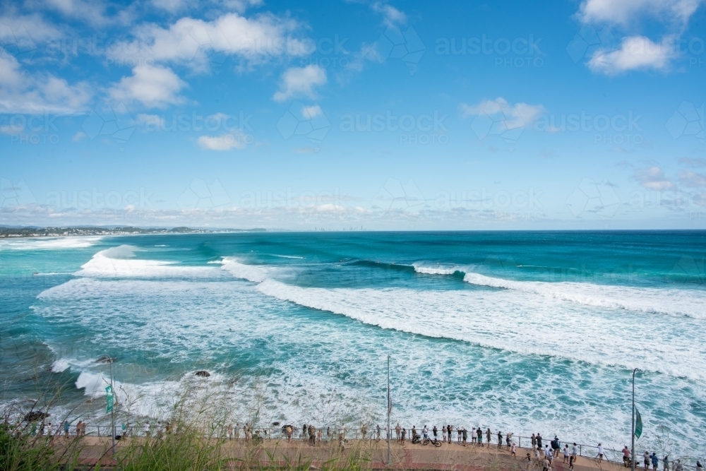 Lots of spectaculars on a clear day while surfers are out on the ocean - Australian Stock Image