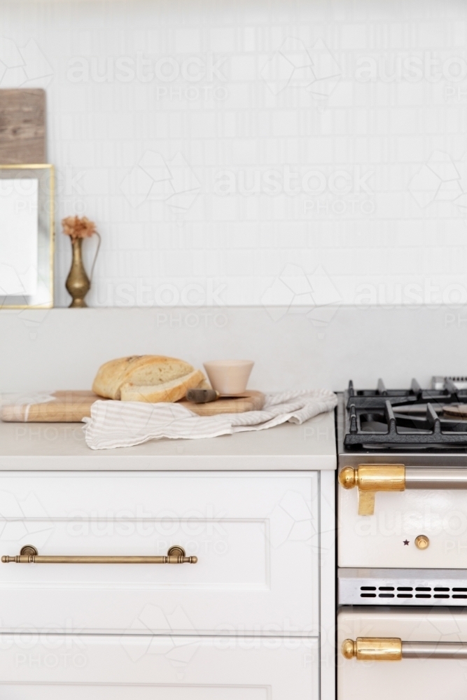 Lovely White kitchen with shaker profile and brass accents - Australian Stock Image